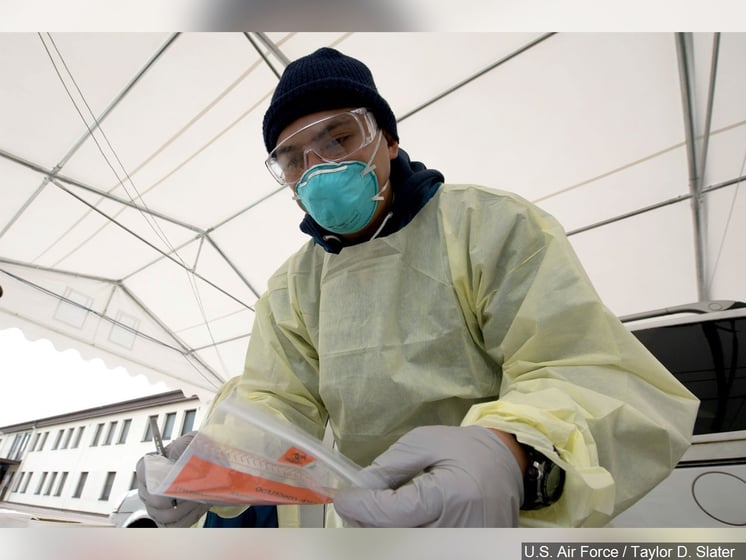 Medical technician, handles supplies in a Coronavirus disease screening drive-thru, Photo Date: March 31, 2020